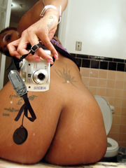 Tattoed young ebony taking pictures of themselves, she fully